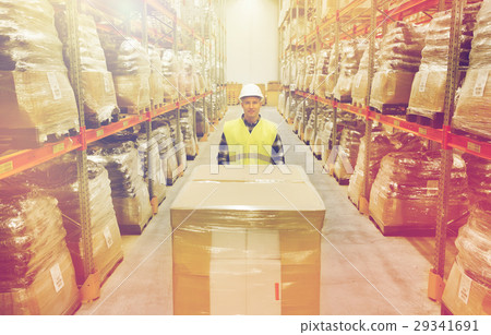 smiling man in hardhat loading cargo at warehouse smiling man in hardhat loading cargo at warehouse 29341691
