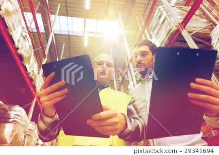 worker and businessmen with clipboard at warehouse worker and businessmen with clipboard at warehouse 29341694