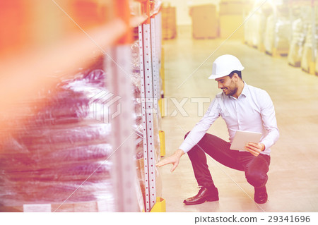 happy businessman with tablet pc at warehouse happy businessman with tablet pc at warehouse 29341696
