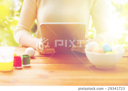 close up of woman with tablet pc and easter eggs 29341723