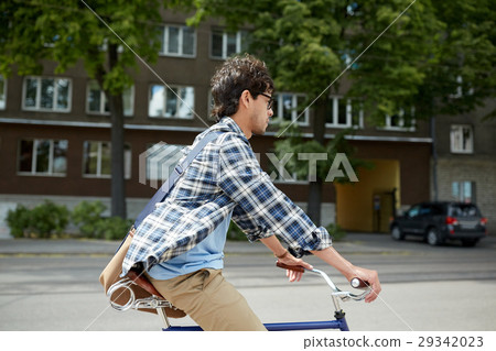 young hipster man with bag riding fixed gear bike 29342023