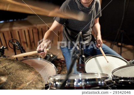 male musician playing drums and cymbals at concert 29342046