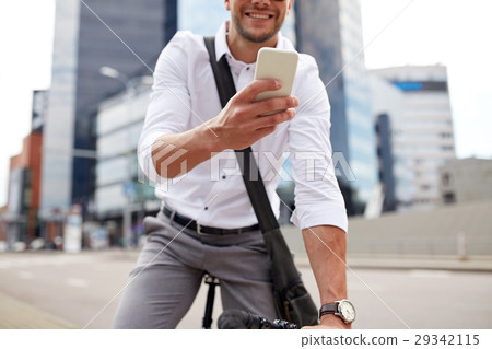 man with smartphone and fixed gear bike on street man with smartphone and fixed gear bike on street 29342115