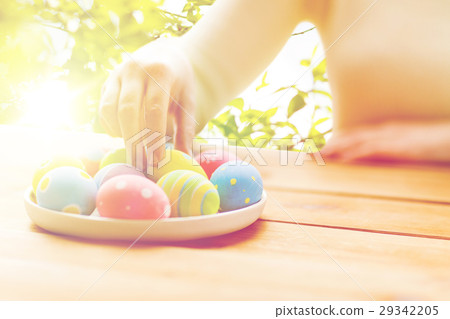 close up of woman hands with colored easter eggs close up of woman hands with colored easter eggs 29342205