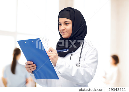 muslim female doctor in hijab with clipboard 29342211