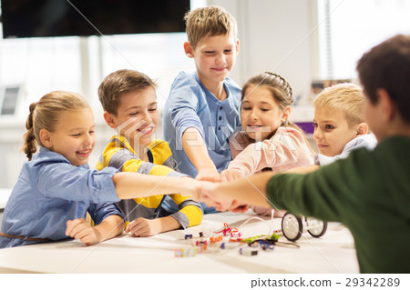 happy children making fist bump at robotics school 29342289