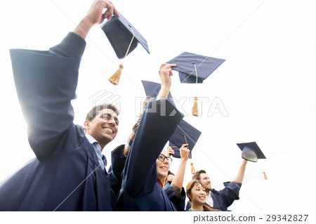 happy students or bachelors waving mortar boards 29342827