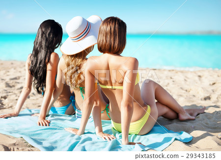 group of women in swimwear sunbathing on beach group of women in swimwear sunbathing on beach 29343185