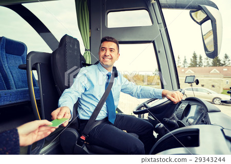bus driver taking ticket or card from passenger 29343244