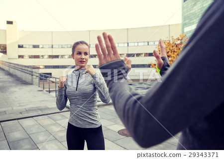 woman with trainer working out self defense strike woman with trainer working out self defense strike 29343371
