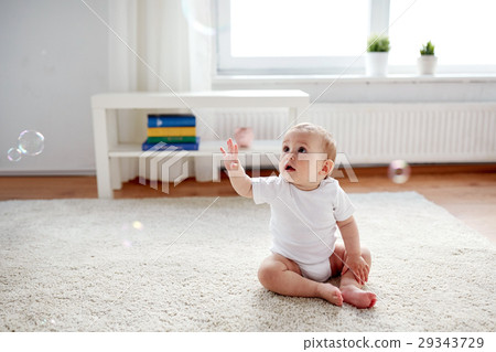happy baby with soap bubbles at home 29343729