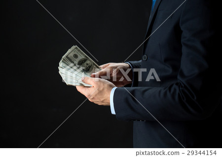 close up of businessman hands holding money 29344154