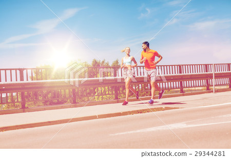 smiling couple running at summer seaside smiling couple running at summer seaside 29344281