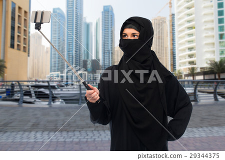 muslim woman in hijab taking selfie by smartphone muslim woman in hijab taking selfie by smartphone 29344375