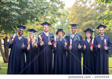 happy students with diplomas showing thumbs up 29344504
