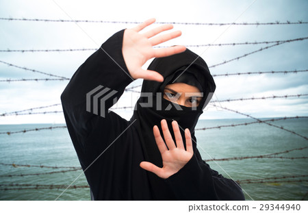 muslim woman in hijab making protective gesture muslim woman in hijab making protective gesture 29344940