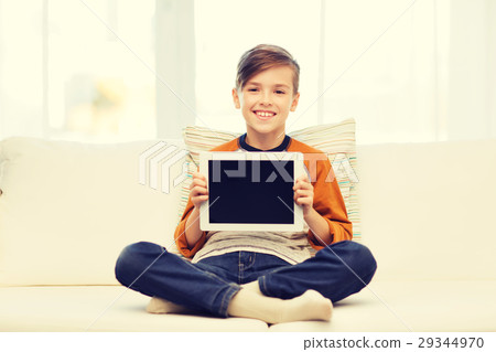smiling boy with tablet computer at home smiling boy with tablet computer at home 29344970