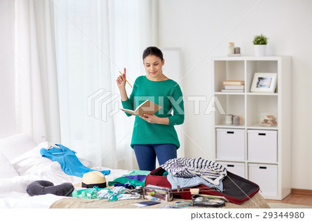 woman with notebook planning her trip at home woman with notebook planning her trip at home 29344980