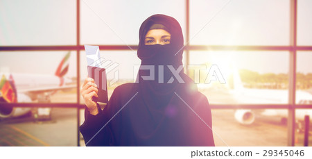 muslim woman with ticket and passport at airport muslim woman with ticket and passport at airport 29345046
