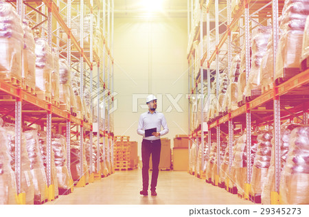 happy businessman with clipboard at warehouse 29345273