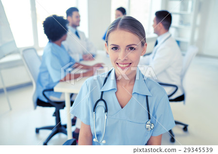 happy doctor over group of medics at hospital 29345539