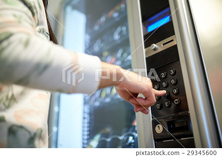 hand pushing button on vending machine keyboard 29345600