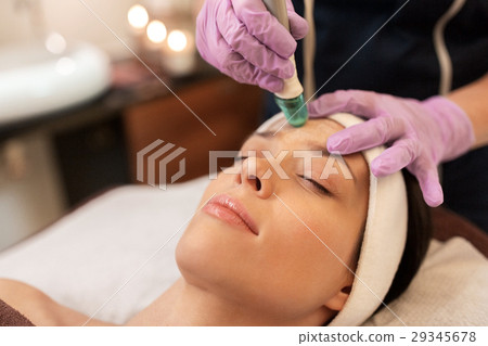 woman having microdermabrasion facial treatment woman having microdermabrasion facial treatment 29345678