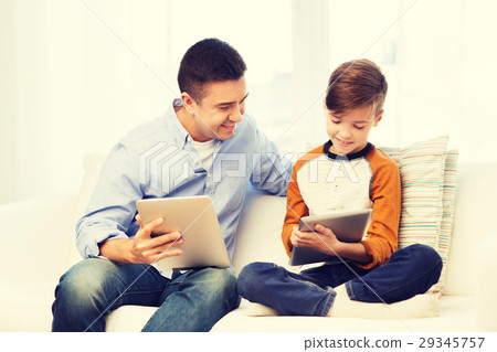 happy father and son with tablet pc at home 29345757