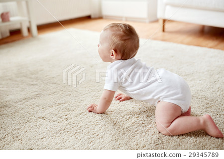 little baby in diaper crawling on floor at home 29345789