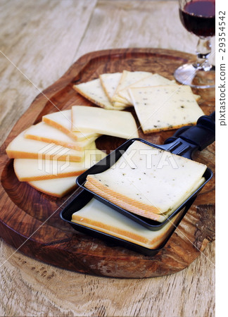 Raclette cheese and wineglass 29354542