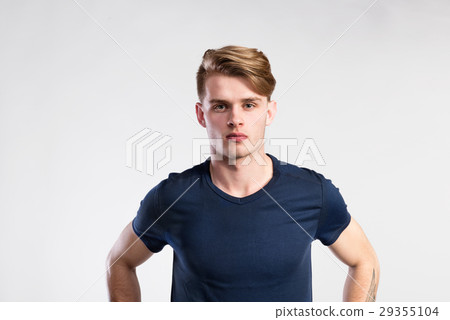 Young handsome hipster man in blue t-shirt, studio Young handsome hipster man in blue t-shirt, studio 29355104