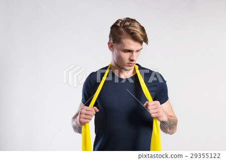 Fitness man working out with resistance bands Fitness man working out with resistance bands 29355122