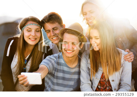Teenagers at summer music festival, taking selfie Teenagers at summer music festival, taking selfie 29355129