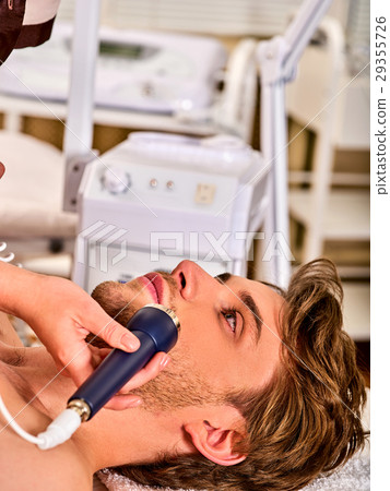 Ultrasonic facial treatment on ultrasound man face 29355726