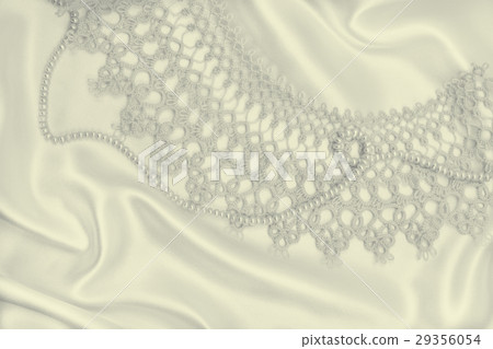 Smooth elegant golden silk or satin with pearls Smooth elegant golden silk or satin with pearls 29356054