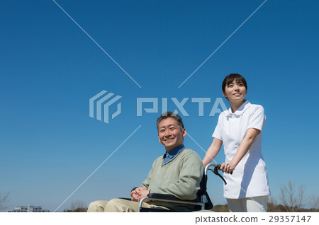 A senior male riding a car and a wheel chair A senior male riding a car and a wheel chair 29357147