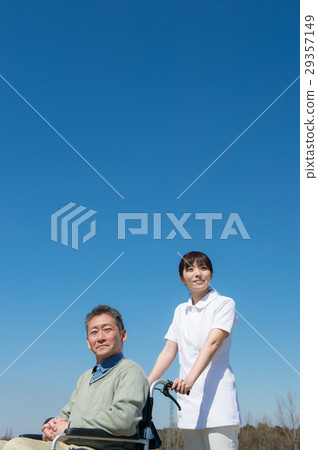 A senior male riding a car and a wheel chair A senior male riding a car and a wheel chair 29357149
