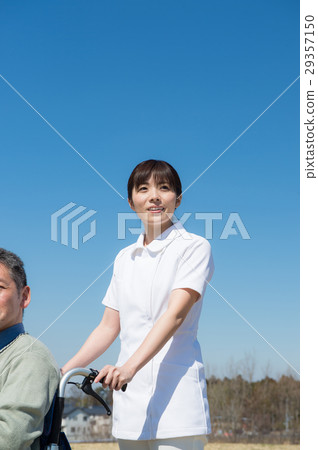 A senior male riding a car and a wheel chair A senior male riding a car and a wheel chair 29357150