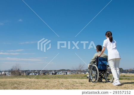 Senior riding in the wheelchair and behind the caregiver Senior riding in the wheelchair and behind the caregiver 29357152