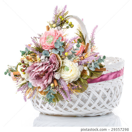 basket with flowers to celebrate Easter on a white 29357298