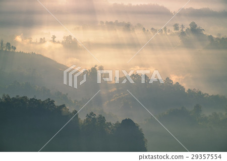 Sunshine beam through on fog hill 29357554