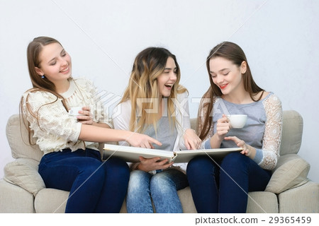 Three happy friends talking and drinking coffee Three happy friends talking and drinking coffee 29365459