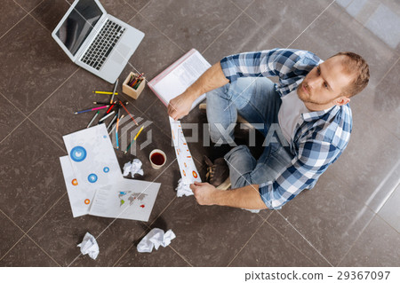 Thoughtful handsome man holding a drawing 29367097