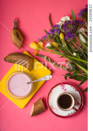 Breakfast with yoghurt, coffee and a bouquet  29369637