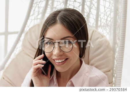 Smiling clever girl telling by cellphone Smiling clever girl telling by cellphone 29370384