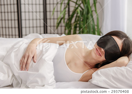 Happy asian woman lying in bed Happy asian woman lying in bed 29370408