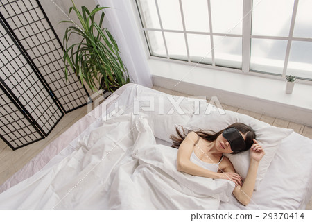 Calm asian female sleeping in bed Calm asian female sleeping in bed 29370414