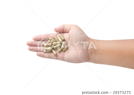 Hand holding medicine pills isolated on white Hand holding medicine pills isolated on white 29373275
