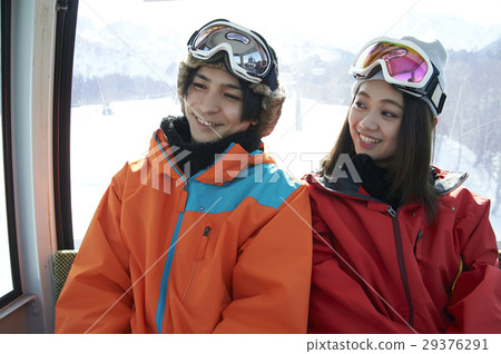 A couple riding a ski resort gondola 29376291