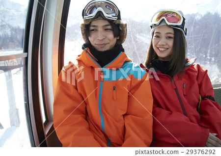 A couple riding a ski resort gondola 29376292